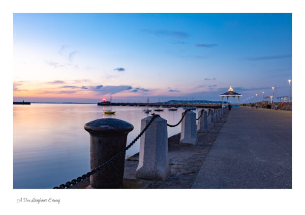 Sun has just set and the long walk down the pier with a lovely sky with a hint of red and the lighthouse in the distance