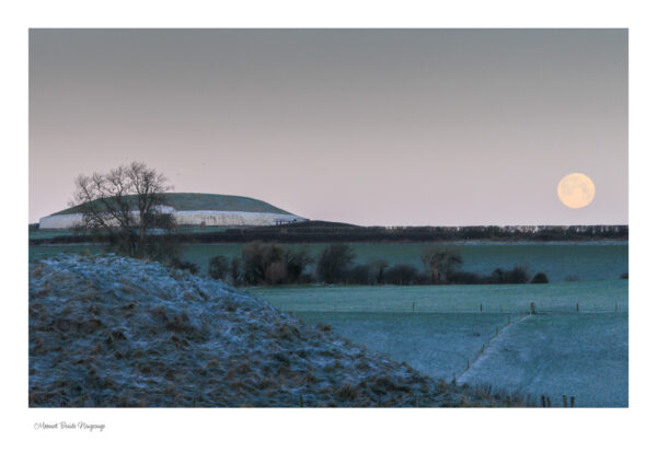 Home The moon setting to the right of Newgrange on a cold and frosty morning